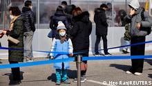 People wait in line to undergo the coronavirus disease (COVID-19) test at a temporary testing site set up in Seoul, South Korea, February 16, 2022. REUTERS/ Heo Ran