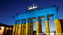 The Brandenburg Gate is illuminated in Ukrainian national colors, in Berlin, Germany February 23, 2022. REUTERS/Michele Tantussi