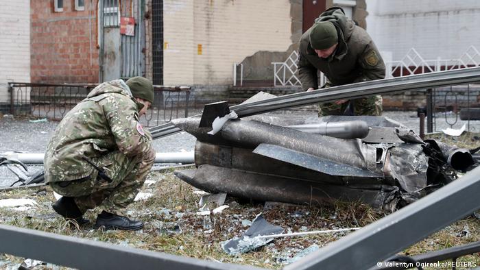 Police officers inspect the remains of a missile that fell in the street in Kyiv, Ukraine, on February 24, 2022