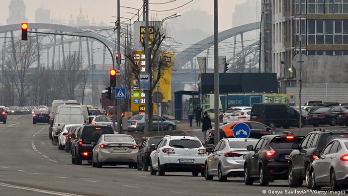 People trying to leave Kyiv in their cars had to queue for petrol.
