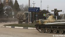 Military vehicles drive along a street, after Russian President Vladimir Putin authorized a military operation in eastern Ukraine, in the town of Armyansk, Crimea, February 24, 2022. REUTERS/Stringer