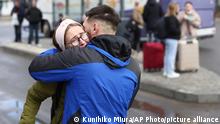 A Ukrainian couple hug at a street after deciding to leave Lviv, western Ukraine for Poland, a neighboring country to evacuate on Feb. 24, 2022. Russian President Vladimir Putin announced a special military operation in Donbas and a multi-pronged attack on several Ukrainian cities has begun ( The Yomiuri Shimbun via AP Images )