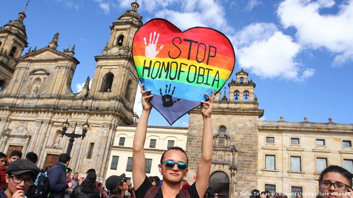 An activist holds a heart-shaped sign reading Stop Homophobia in Bogota, Colombia