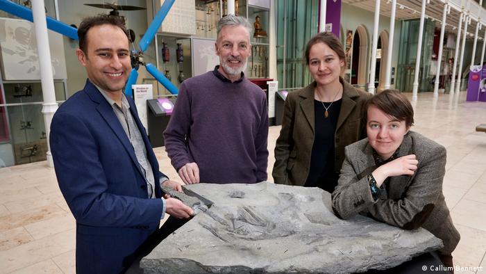 The team at the National Museums Scotland with the fossil. From left to right: Stephen Brusatte, Dugie Ross (who freed the skeleton from the rock with a diamond saw), Amelia Penny and Natalia Jagielska.