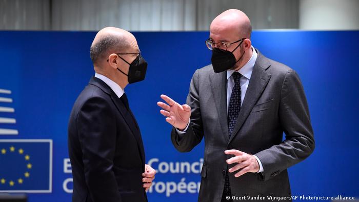 German Chancellor Olaf Scholz speaks with European Council President Charles Michel at the summit