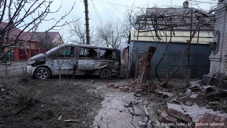 Bombed out vehicle and building in Mariupol