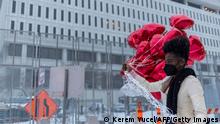 A woman holds heart-shaped balloons before releasing them in front of the US District Court in St Paul, Minnesota, on February 24, 2022. - A jury found three former Minneapolis police officers guilty on February 24 of violating the civil rights of George Floyd, the African-American man whose May 2020 murder sparked nationwide protests. (Photo by Kerem Yucel / AFP) (Photo by KEREM YUCEL/AFP via Getty Images)