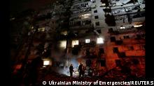 Firefighters work at the site of a damaged residential building, after Russia launched a massive military operation against Ukraine, in Kyiv, Ukraine, February 25, 2022 in this frame grab of a still image use in a video. Ukrainian Ministry of Emergencies/via Reuters TV/Handout via REUTERS ATTENTION EDITORS - THIS IMAGE HAS BEEN SUPPLIED BY A THIRD PARTY. NO RESALES. NO ARCHIVES