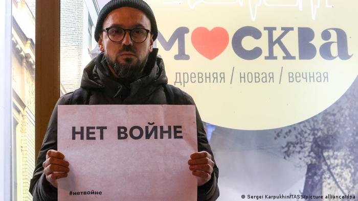 A protester holds a sign during a February anti-war demonstration in Moscow 