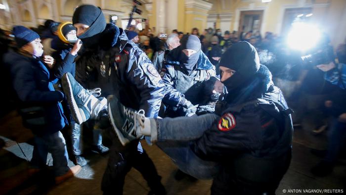 Police carrying away a protester