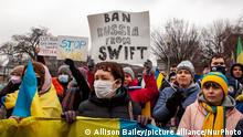Protesters demand that Russia be banned from the SWIFT system during a rally for Ukraine at the White House. This system facilitates international interbank transactions, and banning Russia would severely curtail business transactions and banking. Hundreds of people protested following Russiaâs overnight invasion of Ukraine to demand sanctions on Russia and military assistance for Ukraine. The event was sponsored by United Help Ukraine, a U.S.-based assistance and advocacy organization. (Photo by Allison Bailey/NurPhoto)
