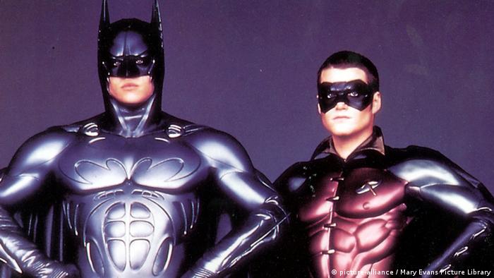 Still from 'Batman Forever': Val Kilmer and Chris O'Donnell post as Batman and Robin in suits with chiseled muscles.