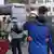 A Ukrainian couple hug at a street after deciding to leave Lviv, western Ukraine for Poland