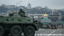 Armoured vehicle and servicemen on a street in Kyiv