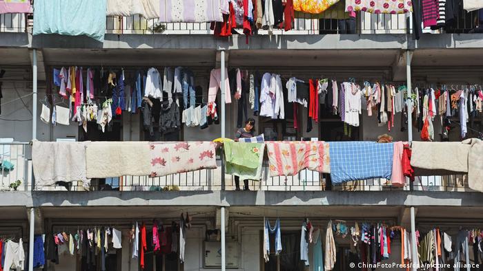 Students from the Hubei University air-dry their laundry on balconies in Wuhan, Hubei Province