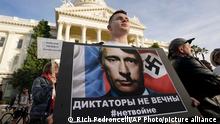 Ivan Semukhian joins others to protest the Russian invasion of Ukraine during a rally at the Capitol in Sacramento, Calif., Thursday, Feb. 24, 2022. (AP Photo/Rich Pedroncelli)