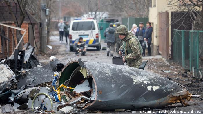 Ukraine-Konflikt - Kiew, Soldat inspiziert Teile des abgestürzten Flugzeuges