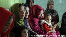 2018, Sharboty Saghira, Irak****
Women and young girls listen to Rasul (not pictured), an Iraqi Kurdish activist with the non-profit organisation WADI, as she peaks about the harms of genital mutilation in Sharboty Saghira, a small village east of regional capital Arbil, on December 3, 2018. - Female genital mutilation appears to have been practiced for decades in Iraq's Kurdish region, usually known for more progressive stances on women's rights. Victims are usually between four and five years old but are impacted for years by bleeding, extremely reduced sexual sensitivity, tearing during childbirth, and depression. (Photo by SAFIN HAMED / AFP) (Photo credit should read SAFIN HAMED/AFP via Getty Images)