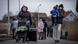 People fleeing from Ukraine pulling luggage and carrying their children People fleeing from Ukraine pulling luggage and carrying their children