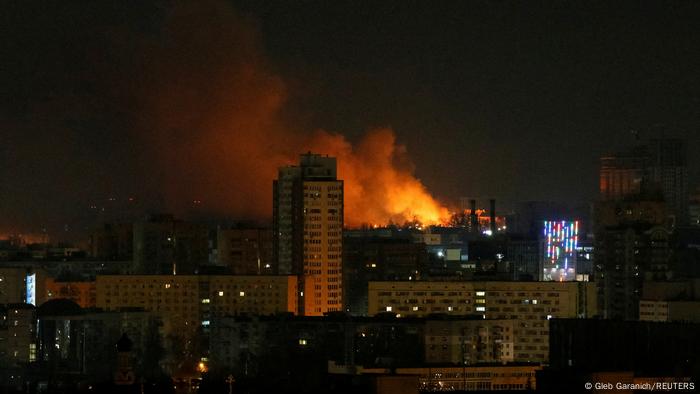 Smoke and flames rise over the buildings as shelling hits near Kyiv