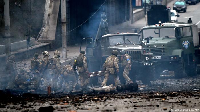 Soliders clear debris from the street