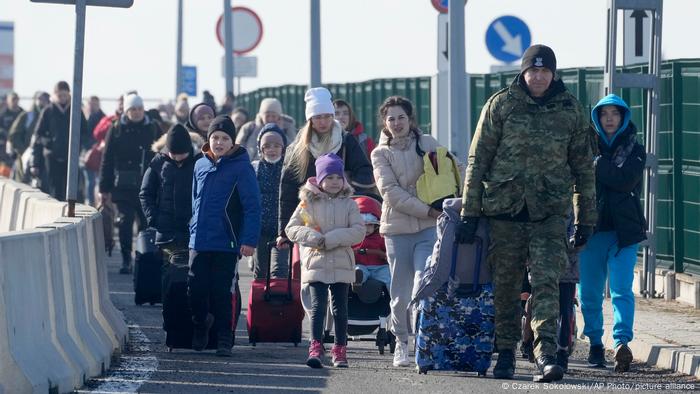 Women and children cross the border into Poland