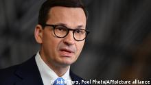 Poland's Prime Minister Mateusz Morawiecki speaks with the media as he arrives for an extraordinary EU summit on Ukraine at the European Council building in Brussels, Thursday, Feb 24, 2022. Russia launched a wide ranging attack on Ukraine on Thursday, hitting cities and bases with airstrikes or shelling, as civilians piled into trains and cars to flee. (John Thys, Pool Photo via AP)