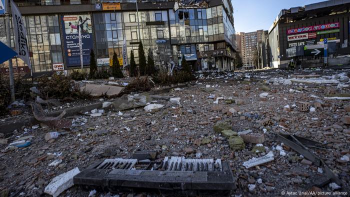 Rubble and a broken keyboard strewn across a commercial plaza in Kyiv