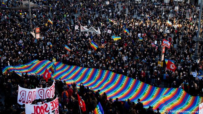 Hundreds of demonstrators surrounding a peace banner at a demonstration in Milan against Russia's invasion of Ukraine