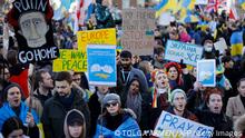 Demonstrators hold placards at a protest rally in central London on February 26, 2022 following Russia's invasion of Ukraine. - The UK government has ordered all assets of President Vladimir Putin and his Foreign Minister Sergei Lavrov frozen over Russia's invasion of Ukraine. (Photo by Tolga Akmen / AFP) (Photo by TOLGA AKMEN/AFP via Getty Images)