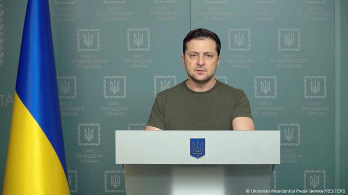 Volodymyr Zelenskyy speaks at a podium