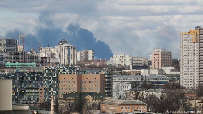 Smoke clouds rise over the cityscape of Kyiv on February 27
