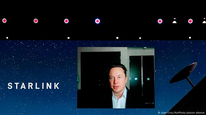 Elon Musk in a box on a screen with the word Starlink next to his head and some dots