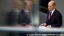 German Chancellor Olaf Scholz speaks during an extraordinary session of the Bundestag (lower house of parliament) on February 27, 2022 in Berlin. - Germany on February 26, 2022 dramatically ramped up its backing for Ukraine's battle against Russia, approving weapons deliveries for Kyiv in a policy U-turn and agreeing to limit Moscow's access to the SWIFT interbank system. In a shift from its longstanding policy of banning weapons exports to conflict zones, Berlin is opening up its Bundeswehr store, pledging to transfer 1,000 anti-tank weapons and 500 Stinger class surface-to-air missiles to Ukraine. (Photo by Odd ANDERSEN / AFP) (Photo by ODD ANDERSEN/AFP via Getty Images)