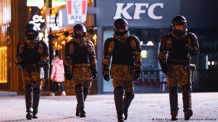 Four Belarusian police officers wearing riot gear