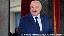 Belarusian President Alexander Lukashenko casts his ballot at a polling station during the Referendum on constitutional amendments in Minsk, Belarus, Sunday, Feb. 27, 2022. Belarusians vote at a referendum on constitutional amendments that could allow country's strongman Alexander Lukashenko to further cement his grip on power until 2035. (Nikolay Petrov/BelTA pool photo via AP)