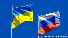 Beautiful national state flags of Ukraine and Russia together at the sky background. 3D artwork concept.