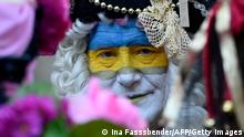 A reveller is made up in the colors Ukraine during a peace march titled Freedom for Ukraine replacing the traditional Rose Monday carnival street parade in Cologne, western Germany, on February 28, 2022. (Photo by Ina Fassbender / AFP) (Photo by INA FASSBENDER/AFP via Getty Images)