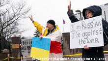 Konstantin Klinovskiy, of Providence, R.I., left, who is originally from Belarus and whose wife is Ukrainian, waves at supporters driving by and beeping as he protests the Russian invasion of Ukraine, Friday, Feb. 25, 2022, outside the Russian Embassy in Washington. At right is a woman, who traveled from West Virginia and asked not to be named, who is Russian and also opposed to the invasion. I wanted to come here for the people of Ukraine, says Klinovskiy, because it's a war it's not a small conflict. Innocent people are dying daily. This world is changing and the ripple effect is hard to understand. (AP Photo/Jacquelyn Martin)