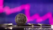 24.2.2022***Russian Rouble coins are seen in front of displayed descending stock graph in this illustration taken, February 24, 2022. REUTERS/Dado Ruvic/Illustration
