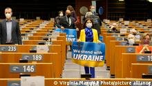 A Member of European Parliament holds a sign in support of Ukraine during an extraordinary plenary session on Ukraine at the European Parliament in Brussels, Tuesday, March 1, 2022. The European Union's legislature meets in an extraordinary session to assess the war in Ukraine and condemn the invasion of Russia. EU Commission President Ursula von der Leyen and Council President Charles Michel will be among the speakers. (AP Photo/Virginia Mayo)