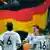 Germany player celebrate in front of Germany flag