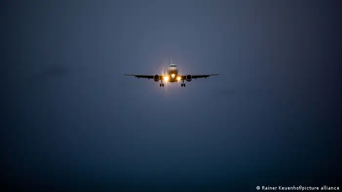 An airplane approaching BER airport at night