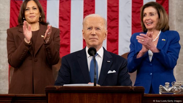 President Joe Biden flanked by Vice President Kamala Harris (L) and House Speaker Nancy Pelosi