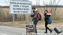 Fleeing from the Ukrainian capital Kyiv, university students from India cross the border by foot in Barabas, Hungary, on February 28, 2022. - More than half a million people have fled Ukraine since Russia launched its full-scale invasion five days ago, with more than half fleeing into Poland, the United Nations said on February 28, 2022. (Photo by Attila KISBENEDEK / AFP) (Photo by ATTILA KISBENEDEK/AFP via Getty Images)