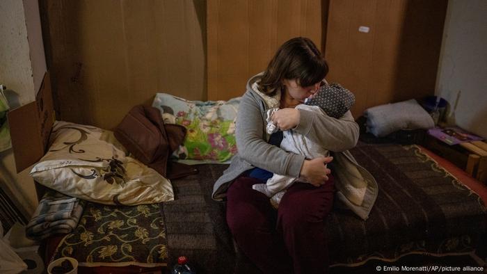 A woman holds her newborn at Okhmadet children's hospital, Kyiv