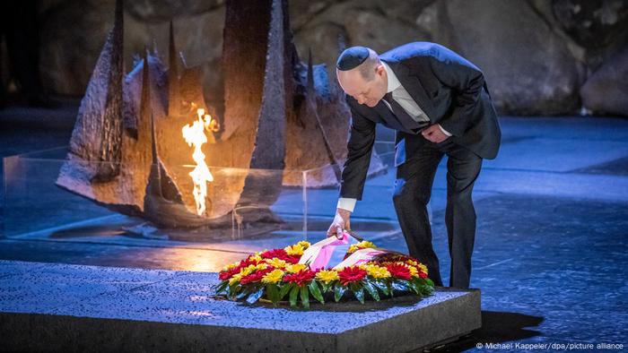 German Chancellor Olaf Scholz lays a wreath at the Yad Vashem Holocaust memorial