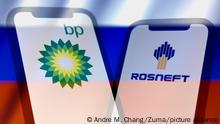 February 27, 2022, Asuncion, Paraguay: Illustration: In-camera multiple exposure image shows logos of BP, a British multinational oil and gas company; and Rosneft, a Russian oil and gas company, on smartphone backdropped by displayed cropped waving flag of Russia. (Credit Image: Â© Andre M. Chang/ZUMA Press Wire