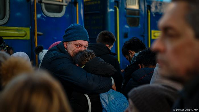 A man says goodbye to his daughter before she boards an evacuation train at Kyiv central train station on February 28, 2022