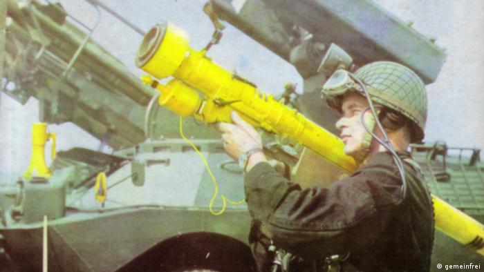 A soldier holds up a Strela missile